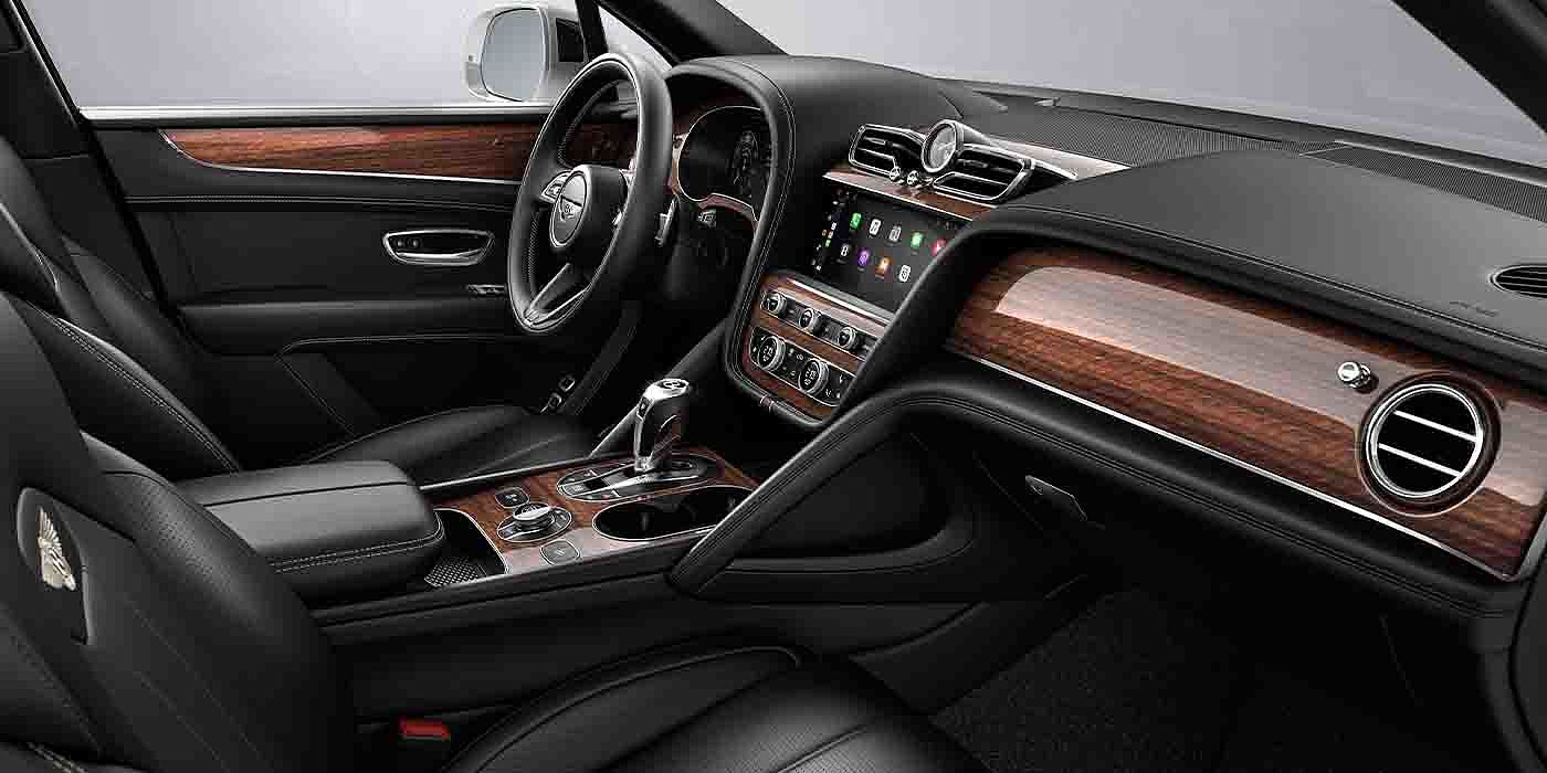 Bentley Leusden Bentley Bentayga EWB interior with a Crown Cut Walnut veneer, view from the passenger seat over looking the driver's seat.