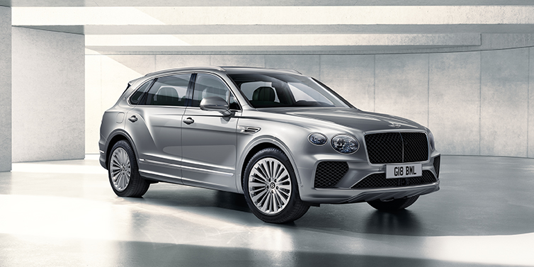 Bentley Leusden Bentley Bentayga Extended Wheelbase SUV front three quarter in Moonbeam paint with a grey background